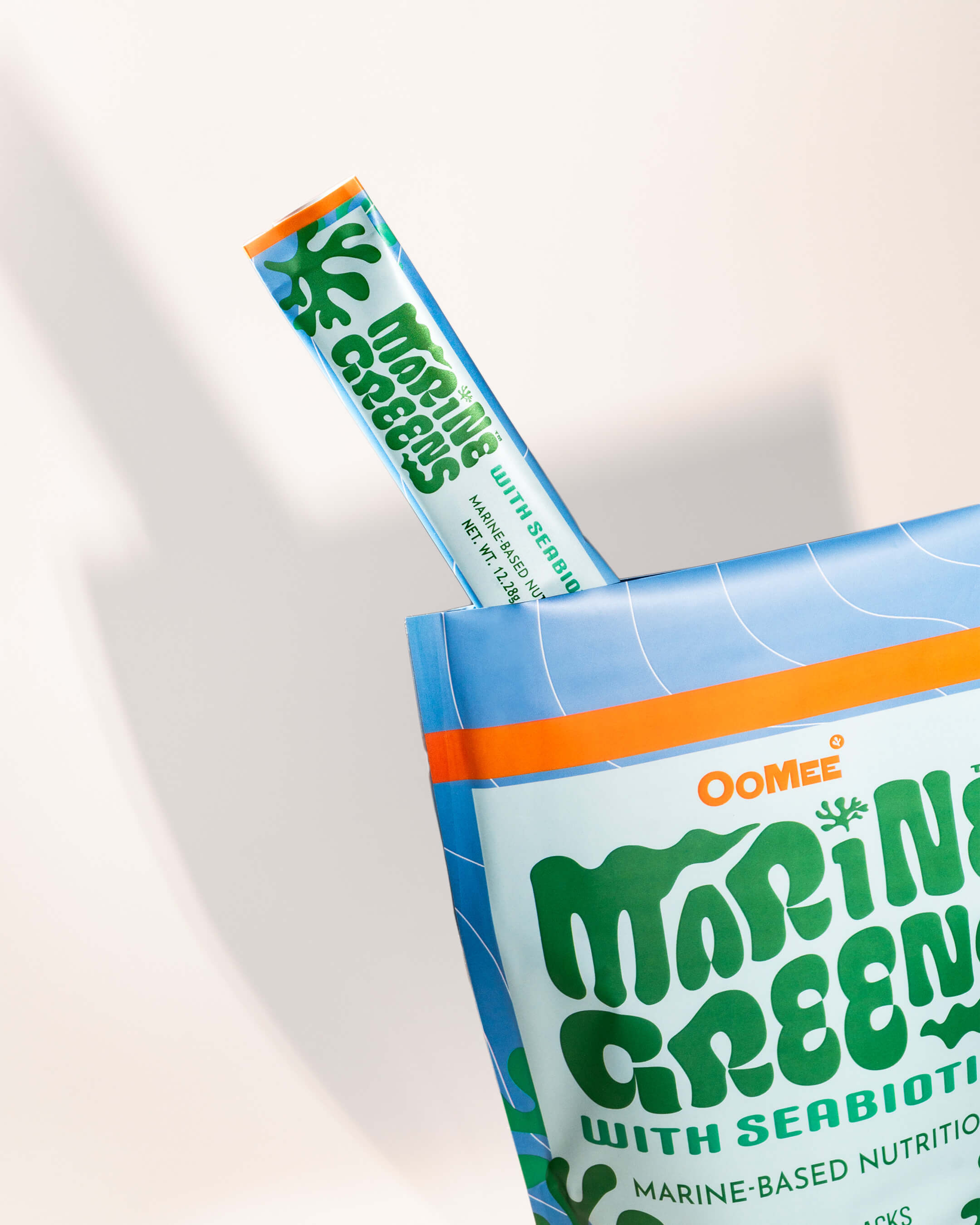 OoMee Marine Greens Stick Packs 15-Serving Stand-Up Pouch with  a Stick Pack peaking out with a white Background - Marine-Based, Green Powder Supplement for Gut Health and Nutrition.