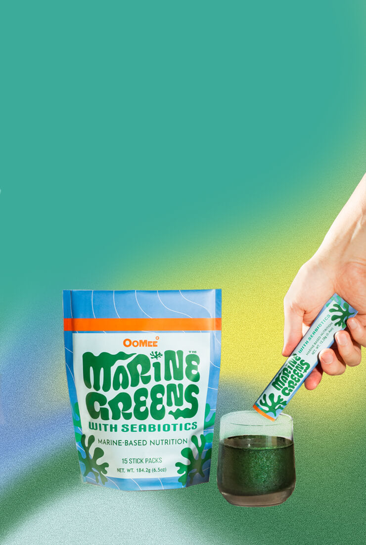 OoMee Marine Greens with Seabiotics™ - 15 Stick Pack Being Poured into a Glass of Marine-Based Nutrition Powder Against Teal Background. Marine based Supplement for health support.